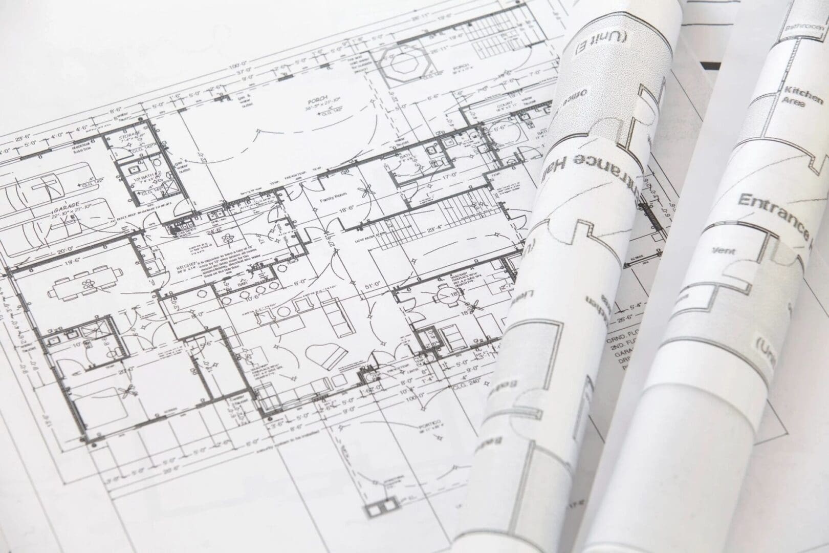 Architectural plans and blueprints on a table for Business Development.