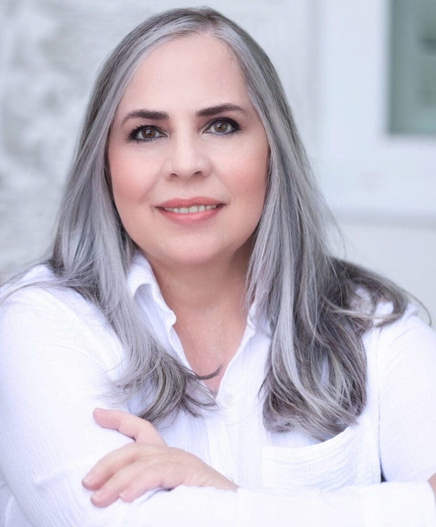 A woman with gray hair is striking a pose for an innovative business solutions photo.