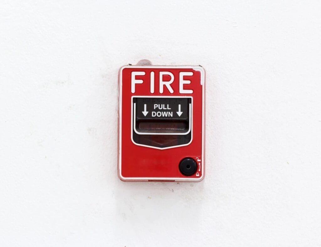 A fire extinguisher on a white wall.