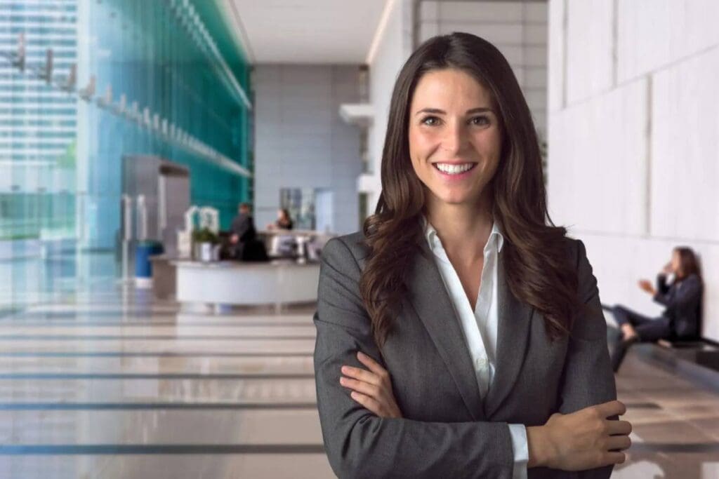 A smiling business woman enjoying her work in a stylish office setting.