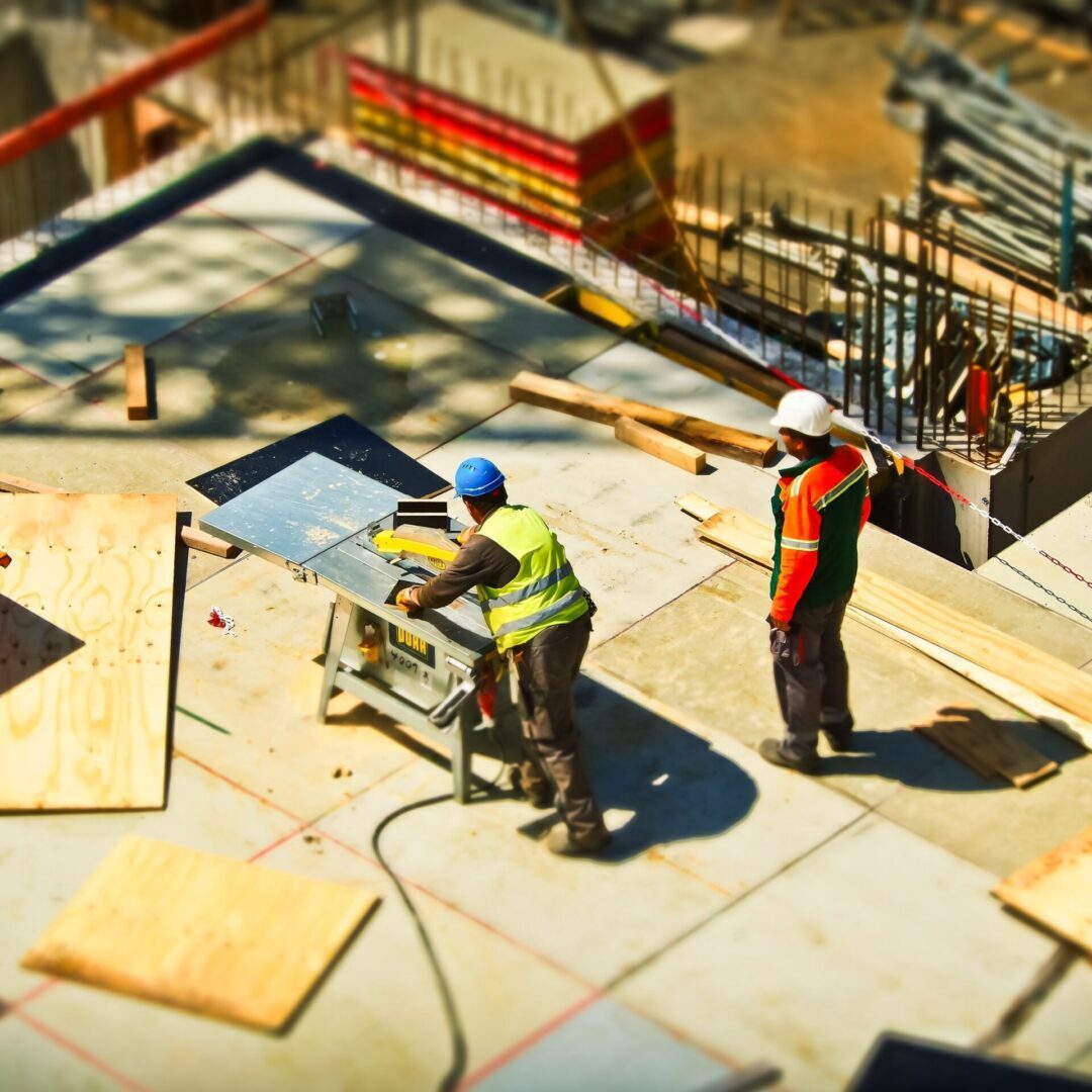 A group of construction workers are working on a construction site, following the recent presidential executive order that waives regulations for infrastructure projects.