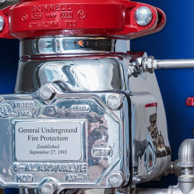 A red and silver fire hydrant with a blue background.