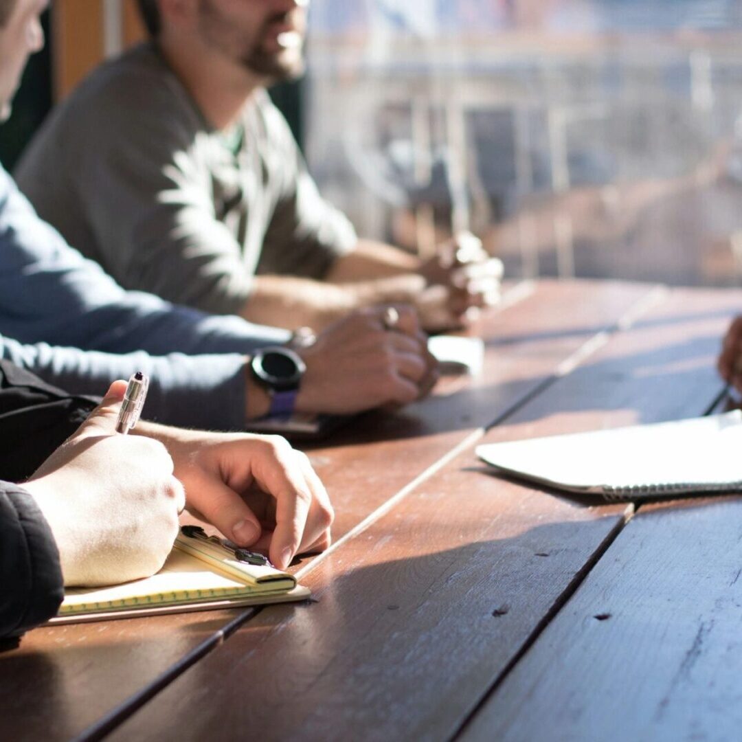 A group of people sitting around a table.