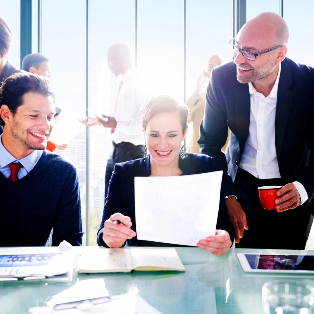 A group of innovative business people sitting around a table, discussing solutions.